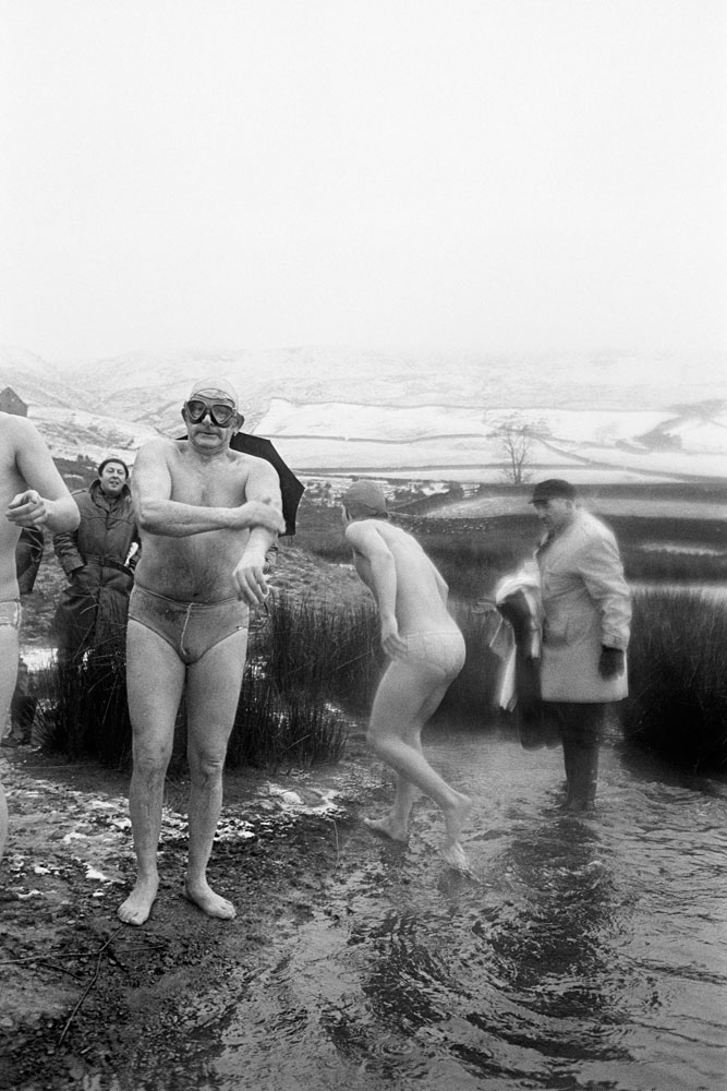 Johnny O'Hara (front) and Percy Bull (right) broke the ice to allow swim to take place, Lee Dam Swim, Todmorden, West Yorkshire, England, 1976. Copyrighted © Martin Parr / Magnum Photos. All rights reserved