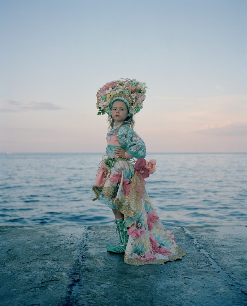 Portrait of Humanity / © Michal Solarski Zlata, Ukraine I met Zlata on the waterfront in Odessa. She had come to the city with her mother to take part in a beauty contest. I thought her Ukrainian dress looked beautiful against the setting sun over the Black Sea. Traditionally, the floral headdresses are worn by young, unmarried women as a sign of their purity; they were once even thought to protect them from evil spirits.