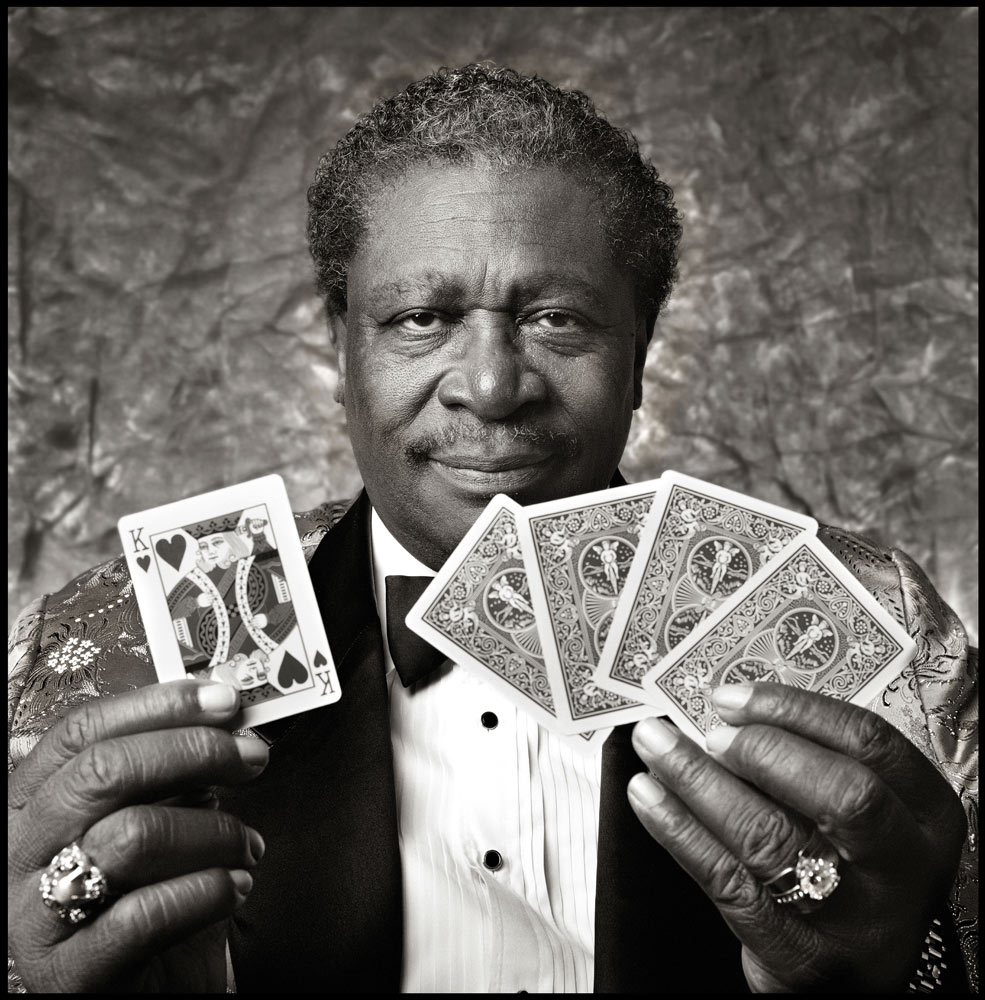 BB King with Cards in 1994. 
 "I had set up a small, portable studio backstage at The Palace Theater in Cleveland Ohio. We finally did our photo session at midnight. Mr. King had just finished the second of two shows that day, but yet he still came to the camera freshly showered and wearing a brand new suit! This shot was used in several publications including Playboy Magazine as well as the companion book to Martin Scorsese's PBS television series called The Blues."
Copyrights to Ken Settle © All rights reserved.