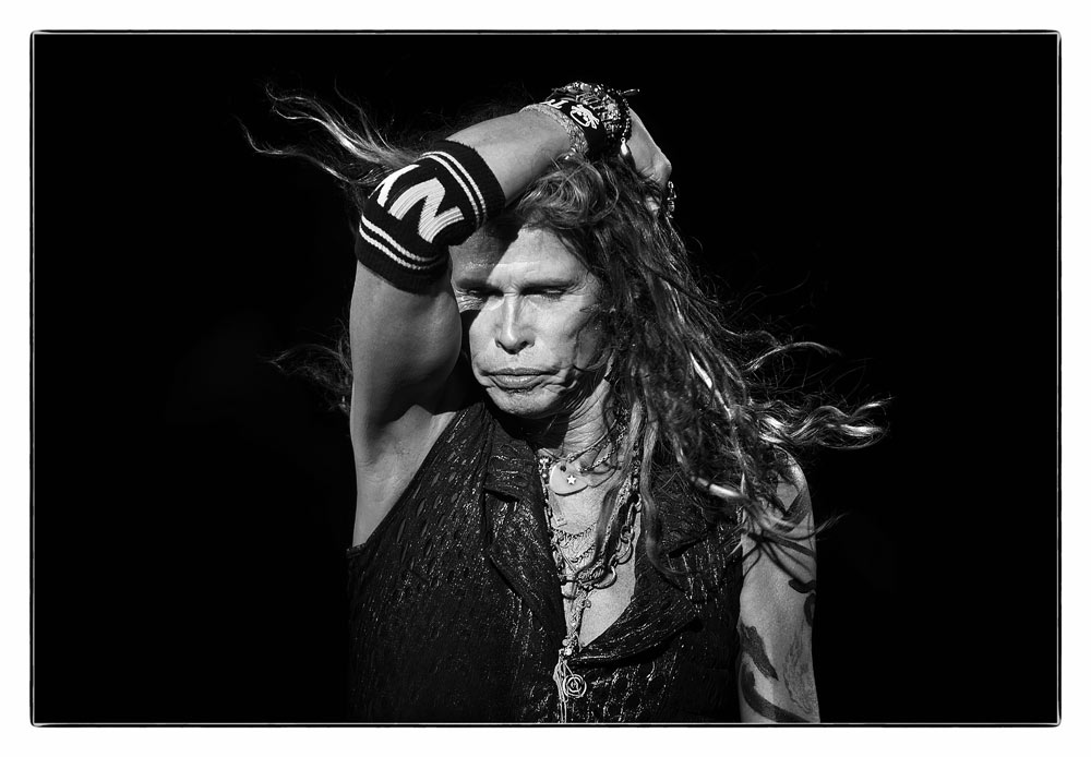Steven Tyler of Aerosmith in 2014.  "This show was a soundboard shoot, and I found it really difficult to follow Steven and feel like you were sort of locking in to what he was doing onstage from that great of a distance.  Catching the interaction that Tyler always seemed to enjoy with  the photographers in the pit required the intimacy and interplay when photographer and subject  are perhaps only a few feet apart. For this shot, Tyler's natural charisma  bridged that distance."
Copyrights to Ken Settle © All rights reserved.