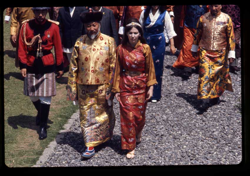 Palden Thondup Namgyal, King of Sikkim, and Hope Cooke, Queen of Sikkim, in brocaded dress, walking to the Tsuklakhang Main Temple (Palace Temple) during the King's birthday celebration, Gangtok, Sikkim. 
Alice S. Kandell © Library of Congress Prints and Photographs Division Washington