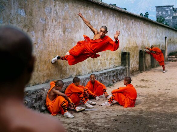 Steve McCurry. An Exclusive Interview in Lens Magazine. Monk Running on Wall, Shaolin Monastery. Henan Province, China, 2004. Fuji Crystal Archive © All rights reserved.