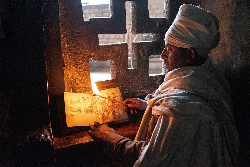 Enlightenment of Man. Ethiopian Priest showing ancient books belonging to the Yemrehana Krestos Church outside Lalibela.
Cody Albert © All rights reserved.