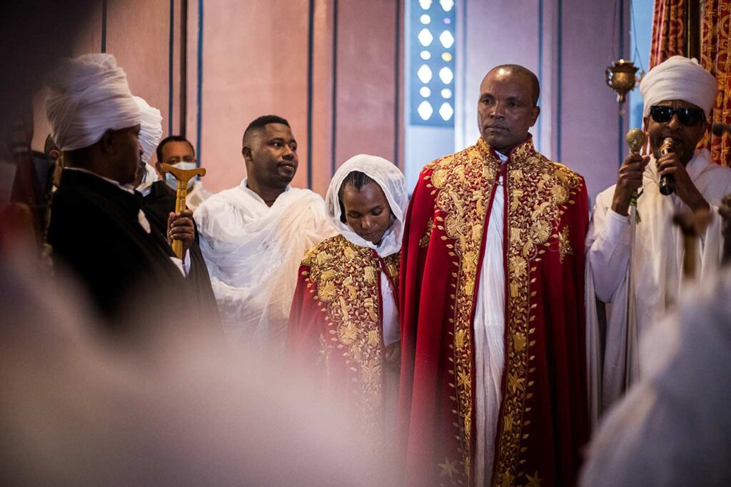 The wedding ceremony came to an end with a series of prayers. Reciting a blessing and escorting Zewdi and Damte out to the main church hall. Meital Dor © All rights reserved.