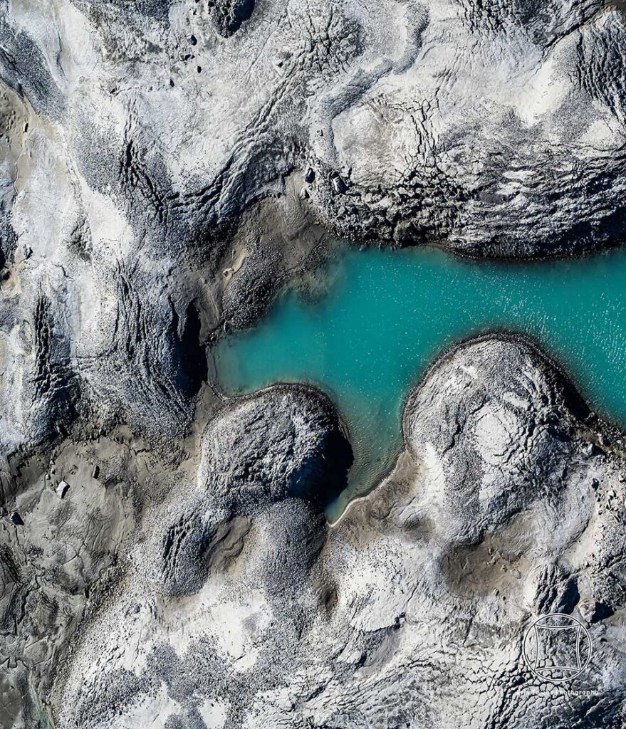 The green and aqua-blue appearance of meltwater is primarily due to the scattering and absorption of sunlight. Perceived color depends on the wavelength of light that is scattered the most.
Erin Towns © All rights reserved. 