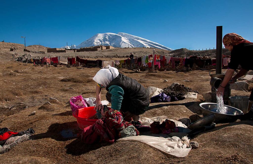 Tashkurgan Laundry
In the shadow of Muztagh-Ata Mountain, women wash their families' clothes in water warmed on a pot-belly stove fueled with manure.