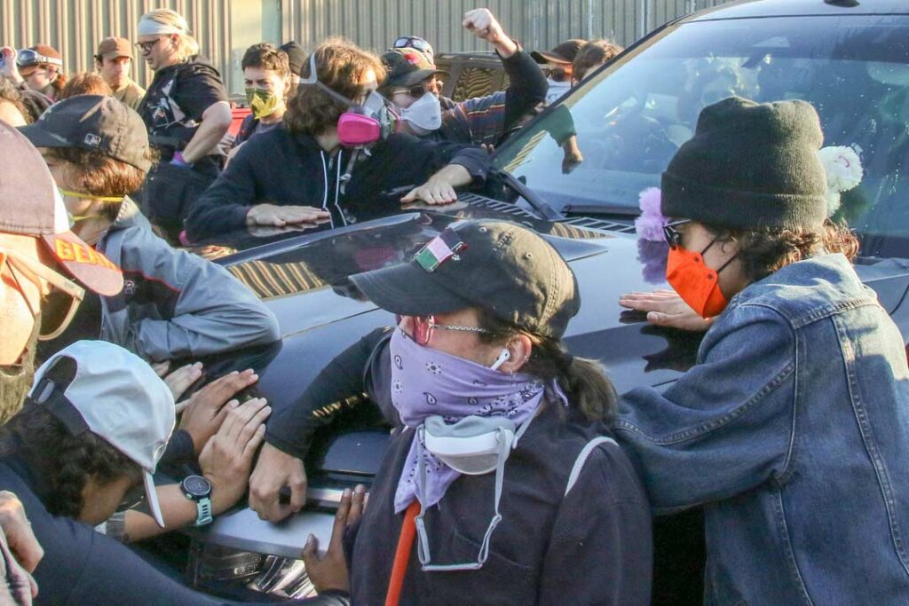 Broadview’s Stand #4
Protesters swarm and beat their hands on an incoming ICE vehicle in an attempt to block it from entering at the side entrance of the ICE detention facility on 25th street and Harvard, Broadview, IL, USA.
Alexandra Buxbaum © All rights reserved.