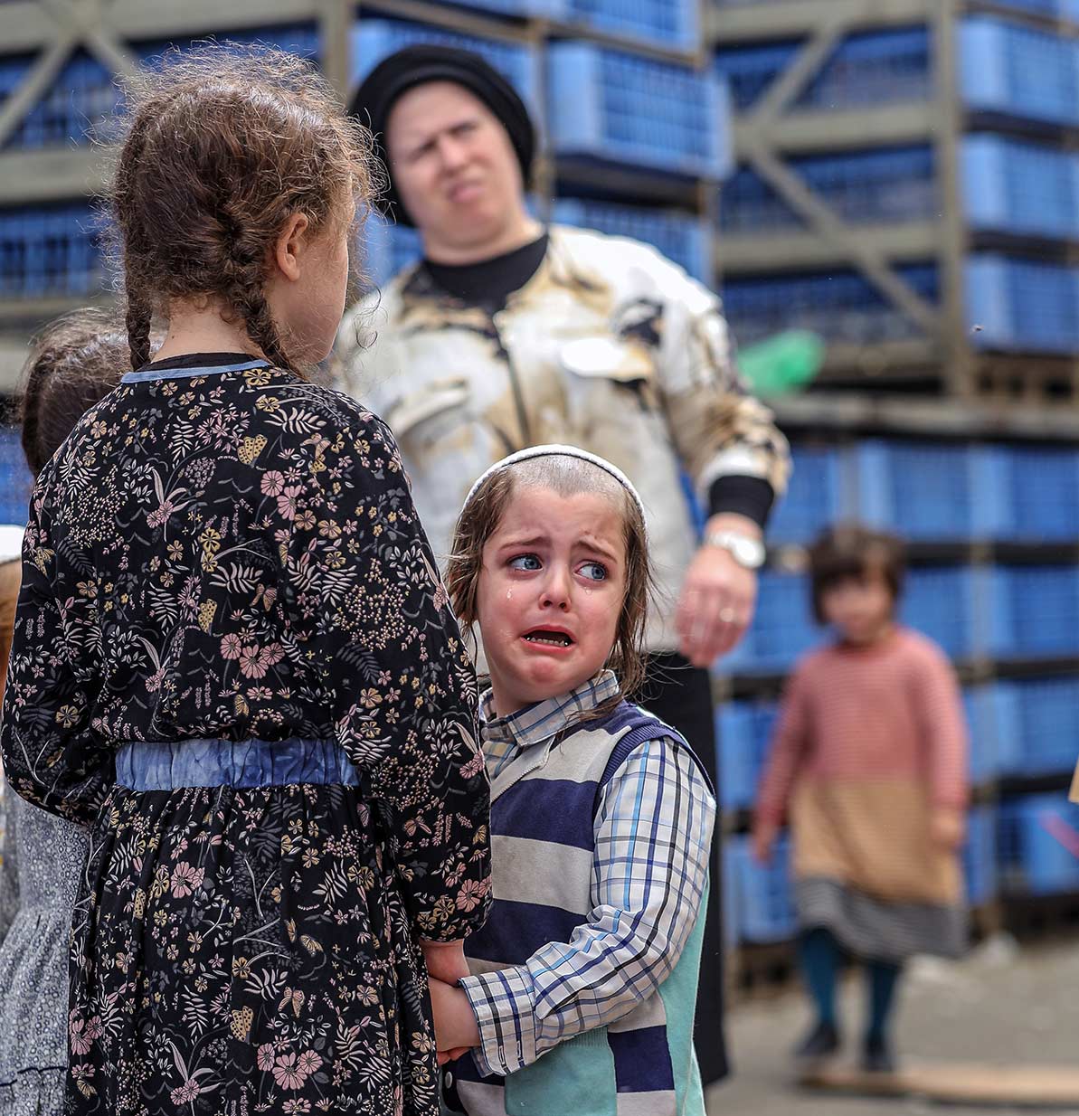 A terrified boy watch as chickens are slaughtered before them.
Yoram Biberman © All rights reserved.