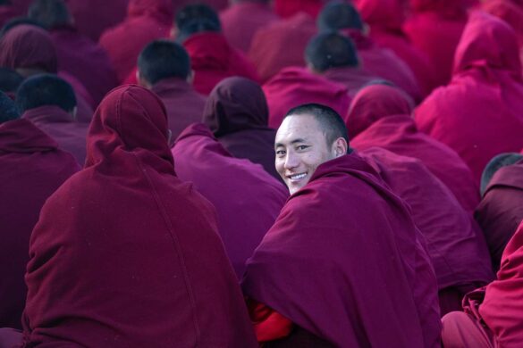 Mass prayer at Yarchen Gar A smiling Buddhist nun in the mass prayer of Yarchen Gar, China. Inger Vandyke © All rights reserved.
