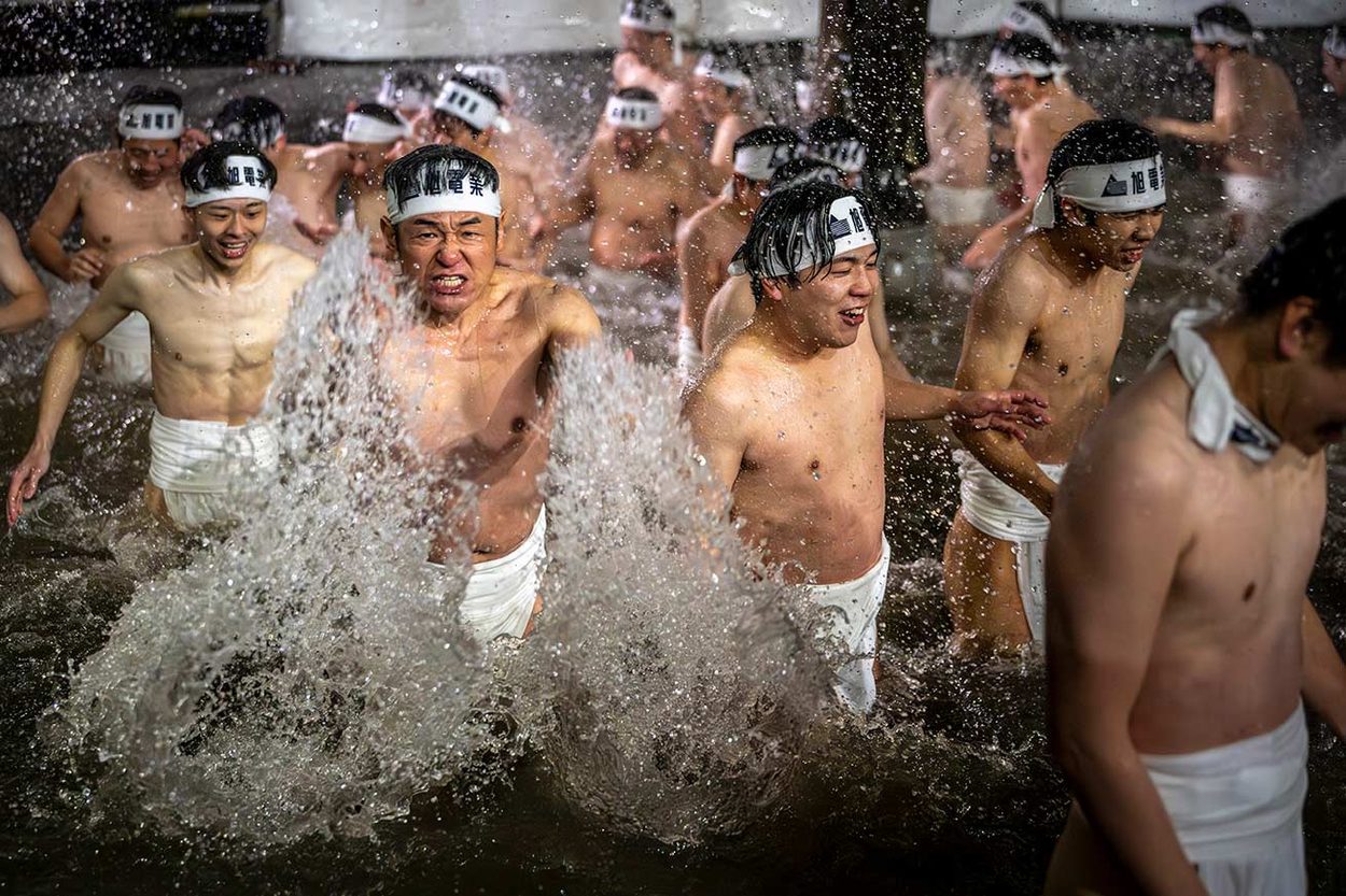 Purification. 
Before entering the temple, and throughout the long wait before the main event, the participants purify themselves in freezing water — circling the temple, chanting, and immersing themselves again and again.
Costanza Rossi © 
All rights reserved