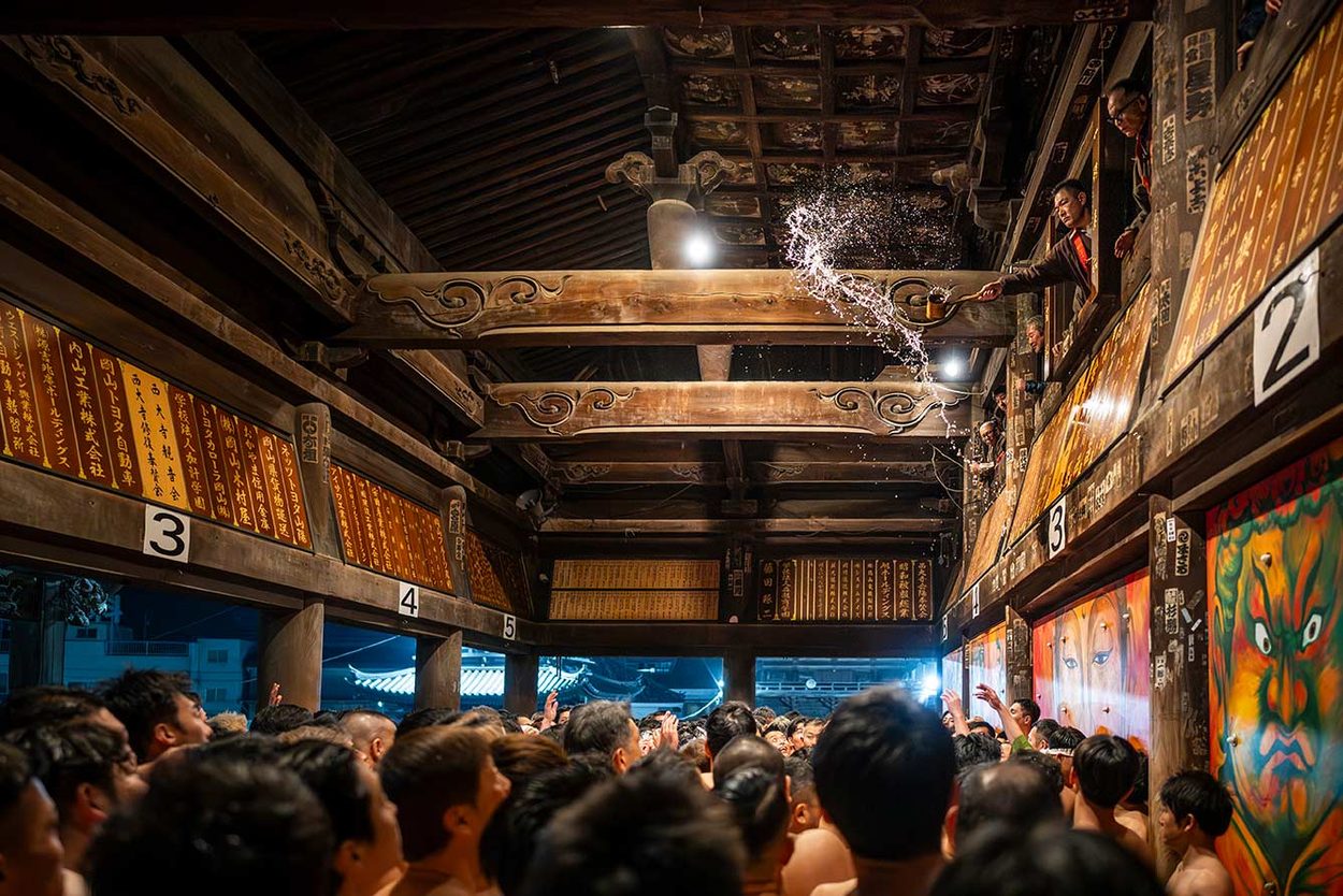 Purification. 
Before entering the temple, and throughout the long wait before the main event, the participants purify themselves in freezing water — circling the temple, chanting, and immersing themselves again and again.
Costanza Rossi © 
All rights reserved