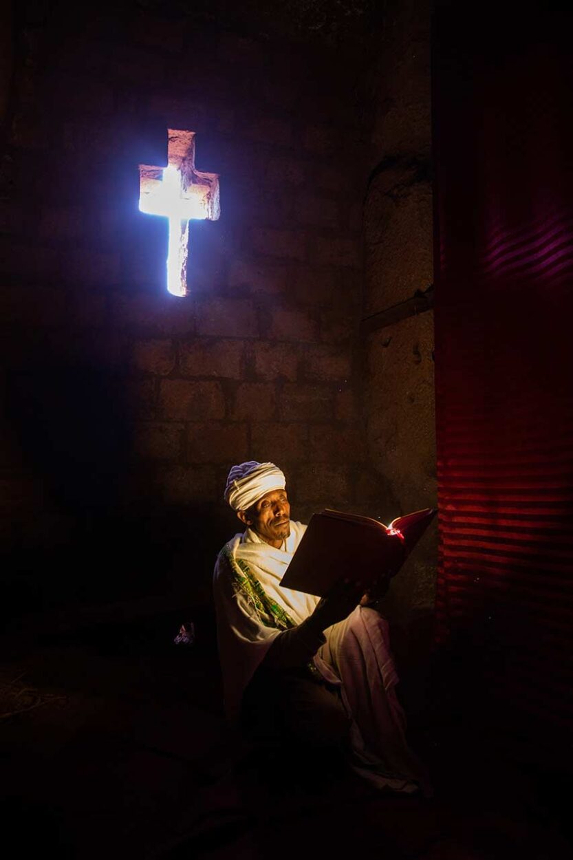 An orthodox priest reading his bible inside one of the churches in Lalibela, Ethiopia
Inger Vandyke © All rights reserved. 
